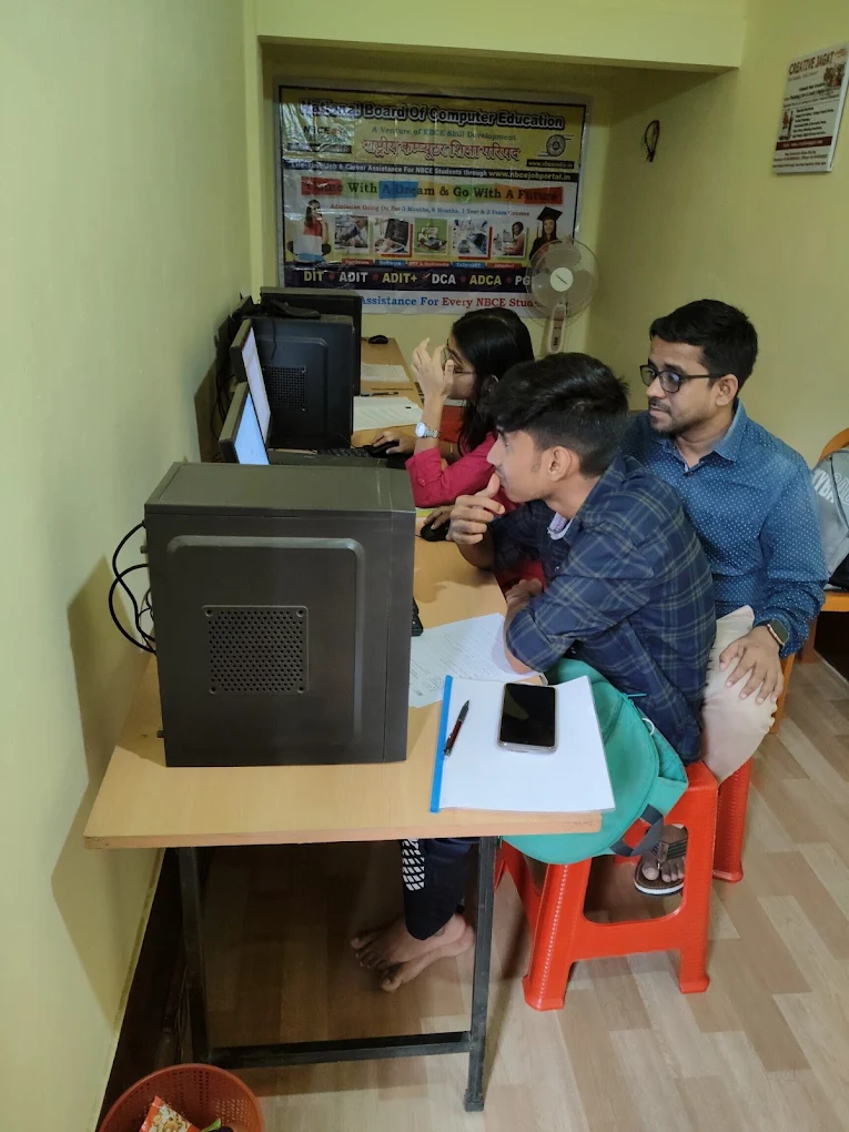 Faculty guiding students on a computer at TECH Jagat, Silchar